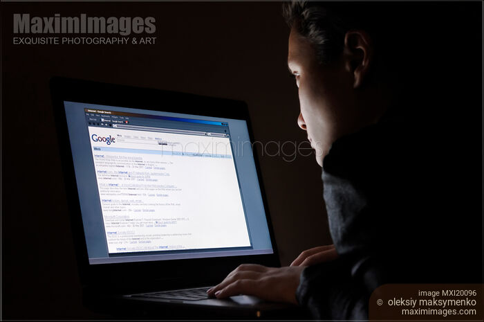 Woman Working on a Computer at Night Stock photo of Woman Working on a Computer at Night Buy commercial use license at MaximImages