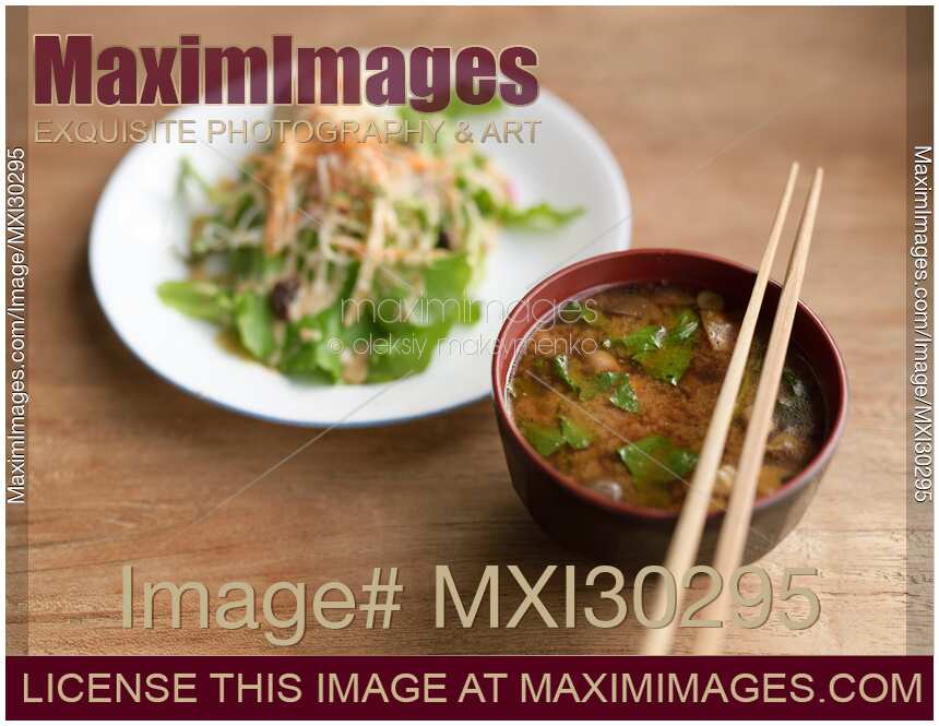 A bowl of spicy Miso soup and vegetable salad in a Japanese restaurant