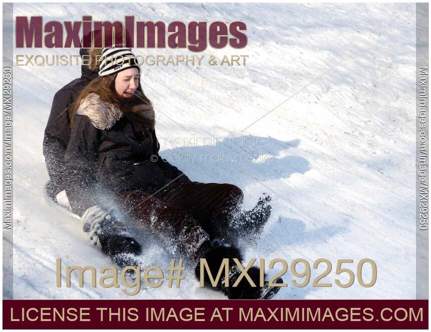 A Girl and a Boy Sliding Down the Hill