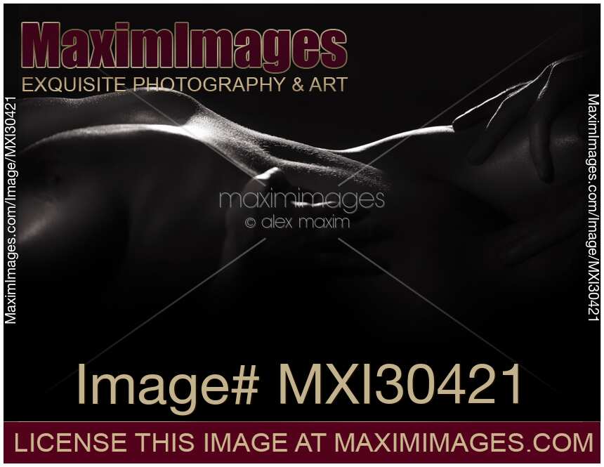 Abstract black and white art nude sexy couple body parts man hands and naked woman body in the shadows