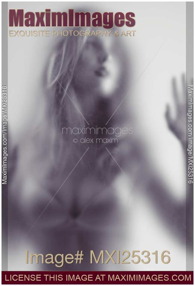 Abstract photo of young woman behind hazy glass