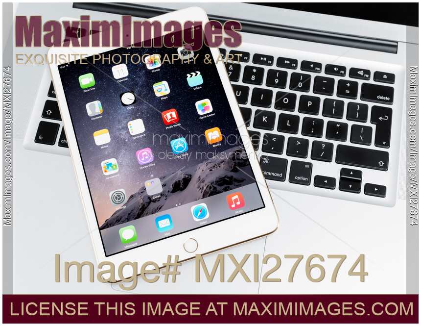 Apple iPad Mini 3 tablet on laptop computer