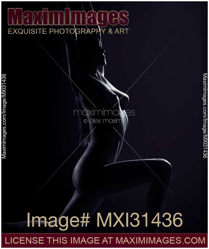 Art nude portrait of a woman in a low lunge yoga pose naked body silhouette on black