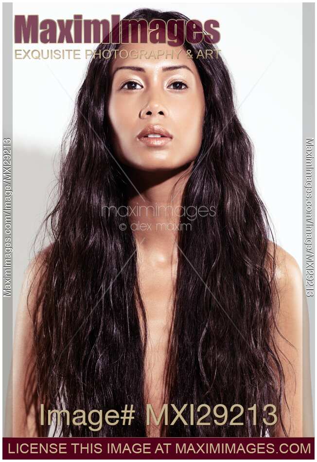 Artistic beauty portrait of a young exotic woman face with long dark hair