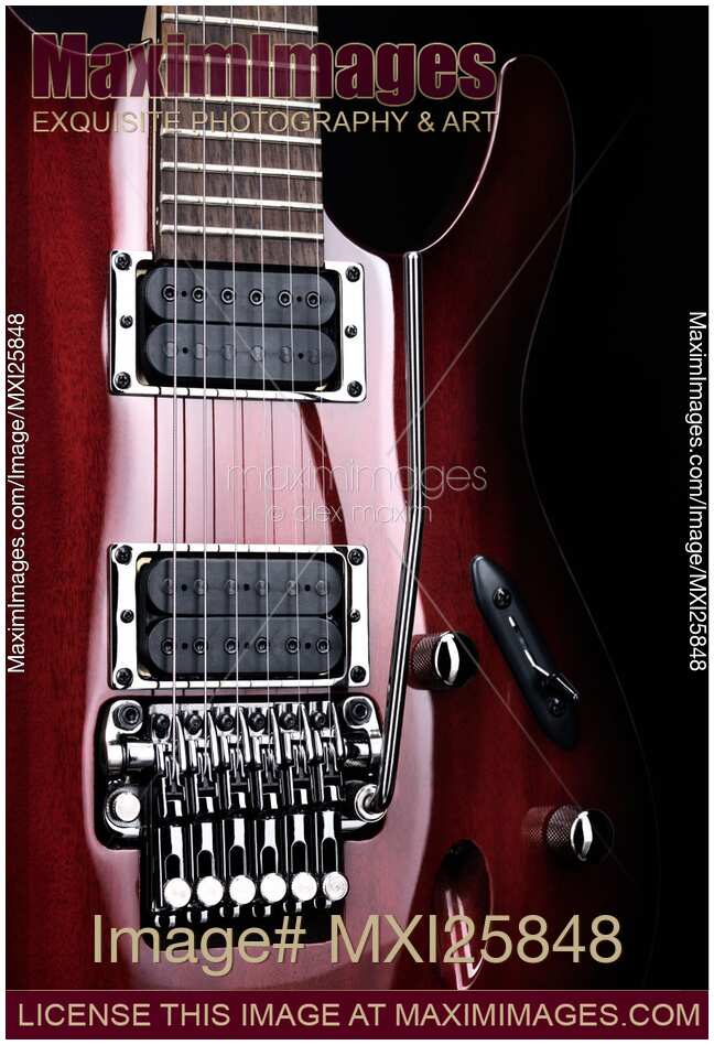 Artistic closeup of red electric guitar