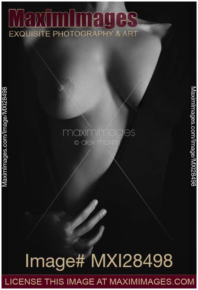 Artistic erotic closeup of woman breast in revealing black dress