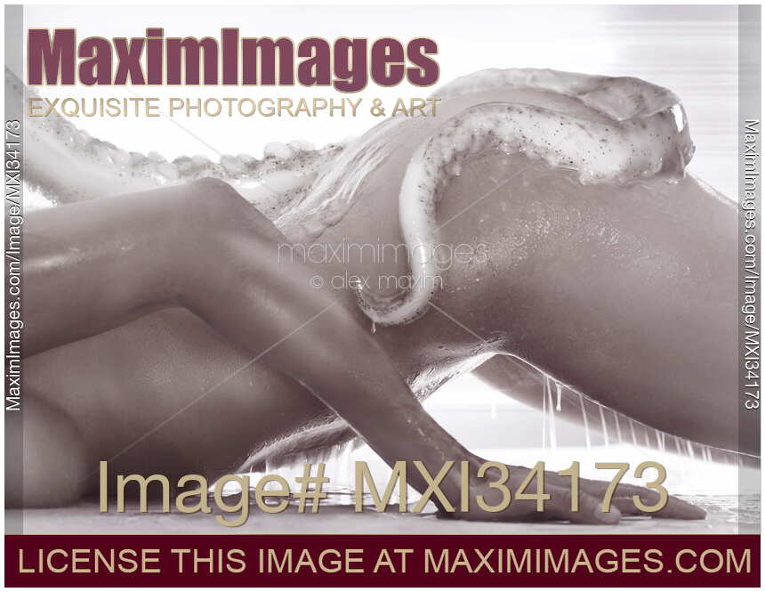 Artistic erotic sci-fi monochrome photo of nude woman with slimy giant tentacle wrapped around her sexy naked body