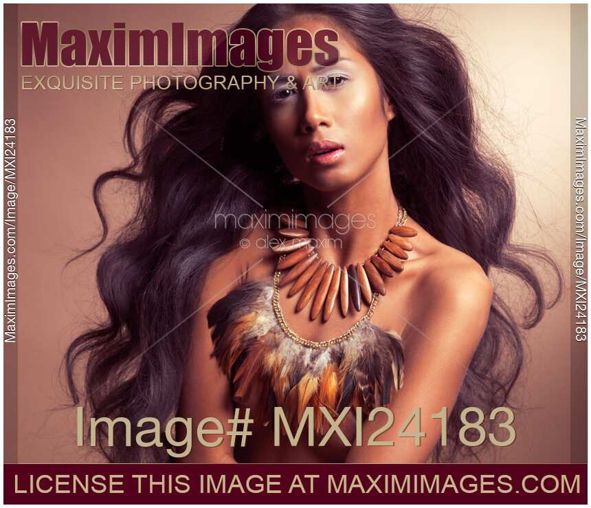 Artistic ethnic portrait of a beautiful young woman with long flying hair