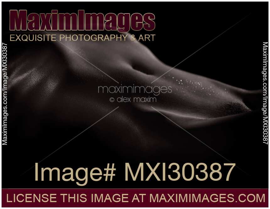 Artistic nude abstract black and white body parts of a sexy woman stomach with shiny wet skin