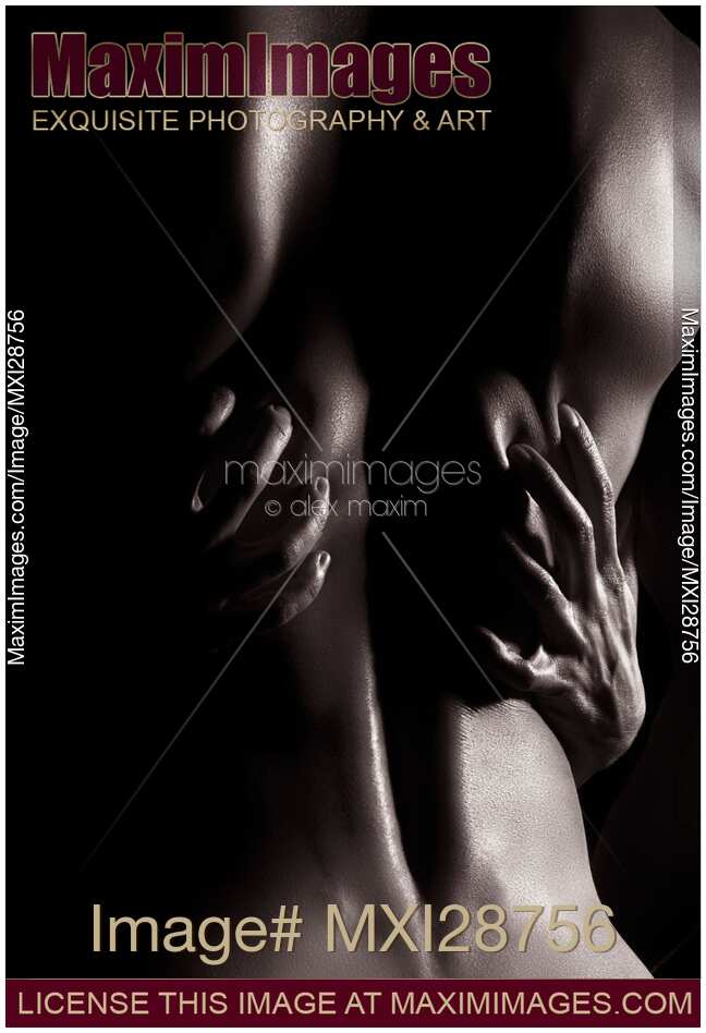 Artistic nude abstract of man back with woman hands on it