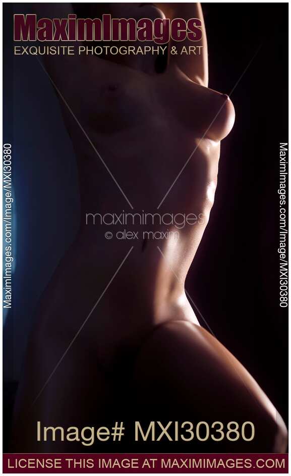 Artistic nude body outline of a woman in a dark room