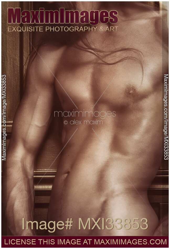 Artistic nude closeup of a nude man bare torso muscular body in golden colors
