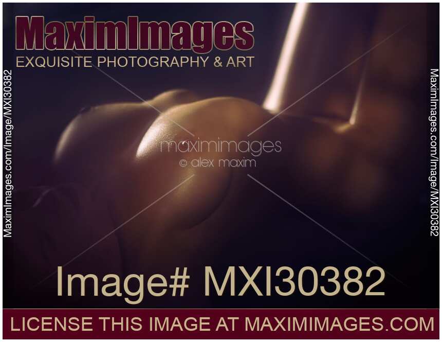 Artistic nude photo of a sexy woman body in soft dim night light