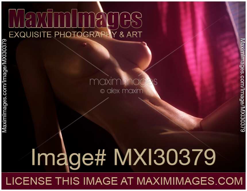 Artistic nude photo of a woman slim sexy body glowing in soft light coming through a pink curtain