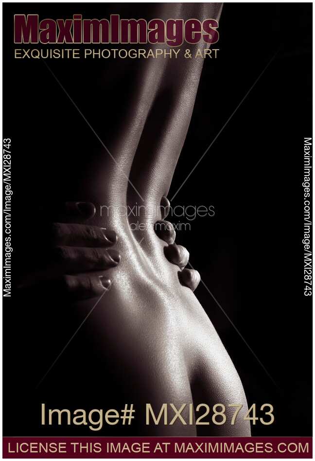 Artistic nude photo of woman body with man hands on her waist