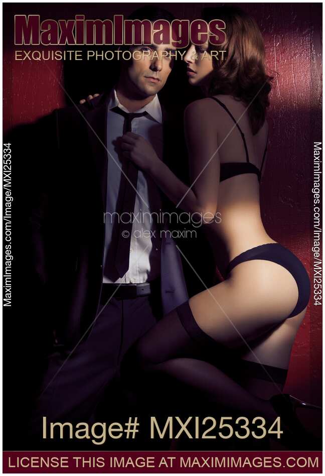 Artistic photo of sexy young couple in dramatic dim light