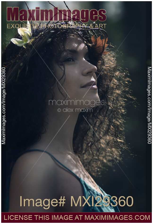 Artistic portrait of beautiful woman face with dreamy serene expression a wreath in her hair