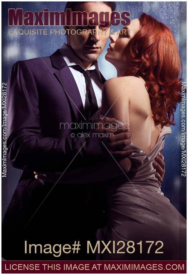 Artistic portrait of couple standing near window