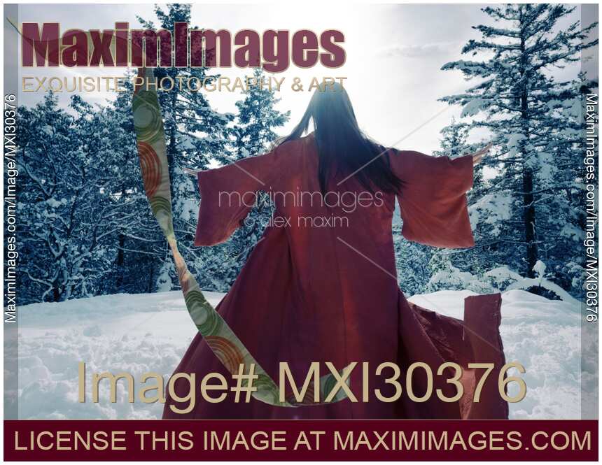 Asian woman in red kimono dancing in the snow spinning around tossing her clothes away