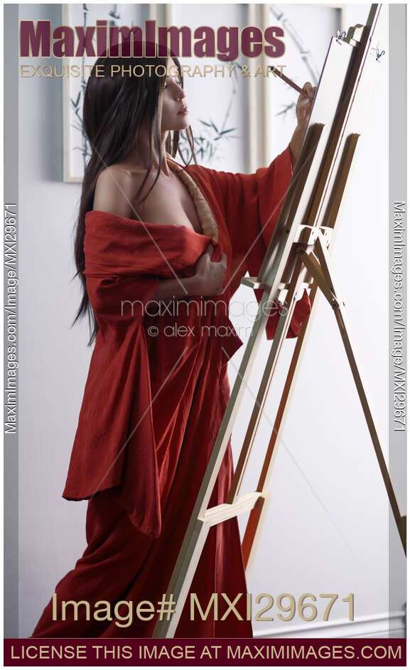 Asian woman sumi-e artist in red kimono painting in her studio artistic portrait