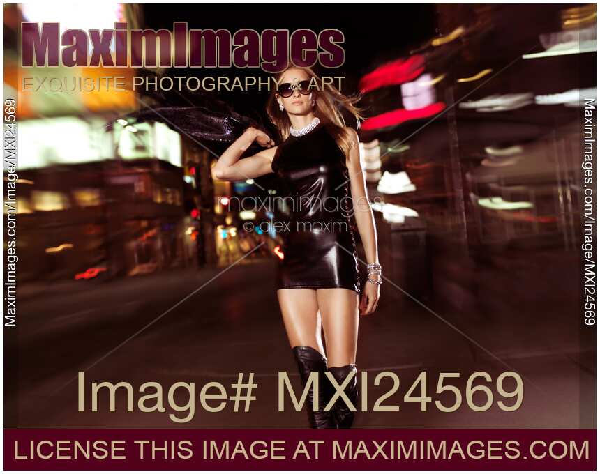 Attractive Young Party Woman Walking Down the Street at Night