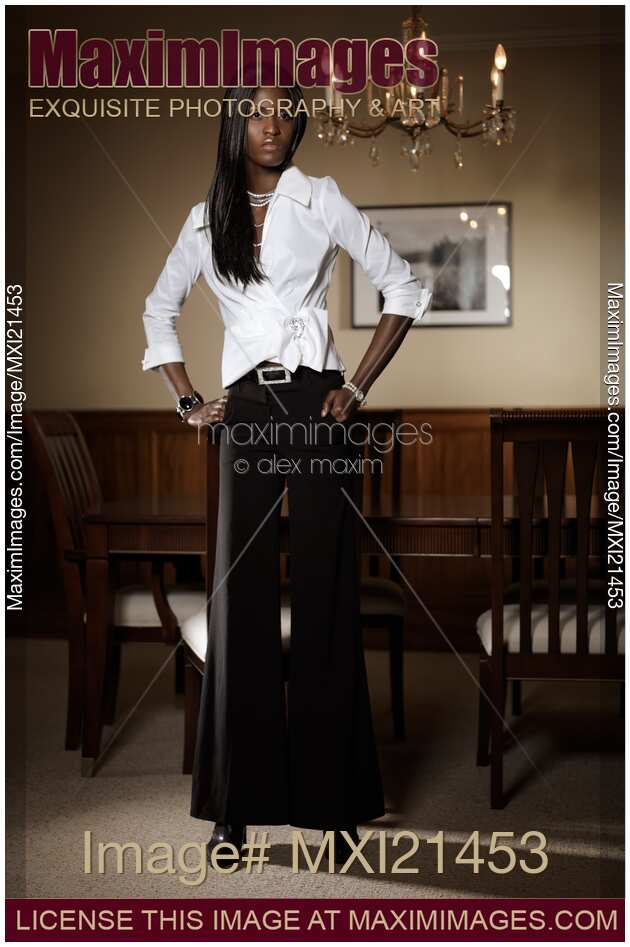 Attractive Young Woman in Trendy Clothes Indoors