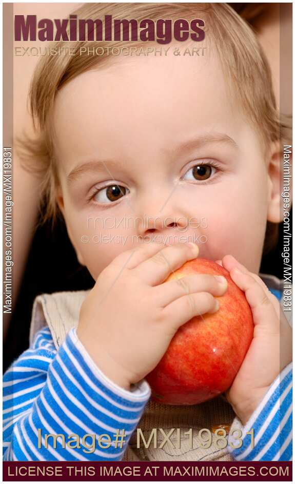Baby boy eating apple