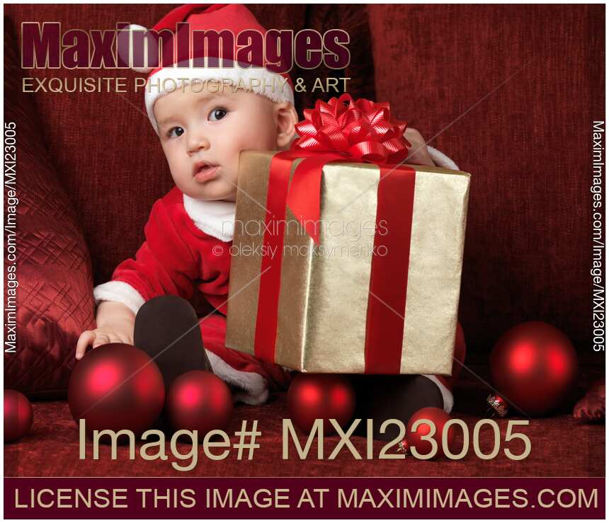Baby Boy in Santa Costume with a Christmas Present