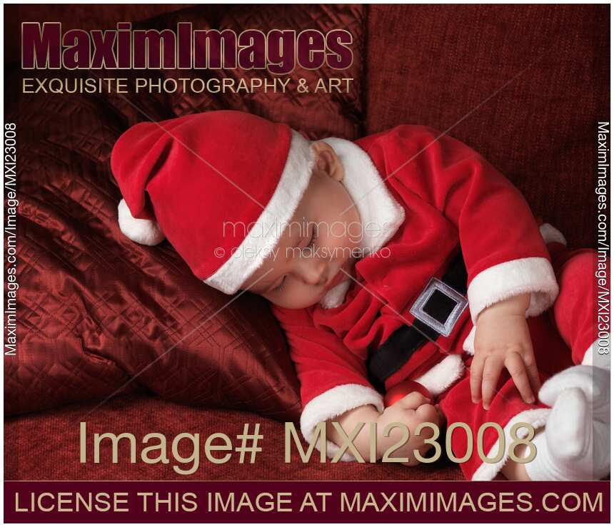 Baby Boy in Santas Costume Sleeping on a Sofa