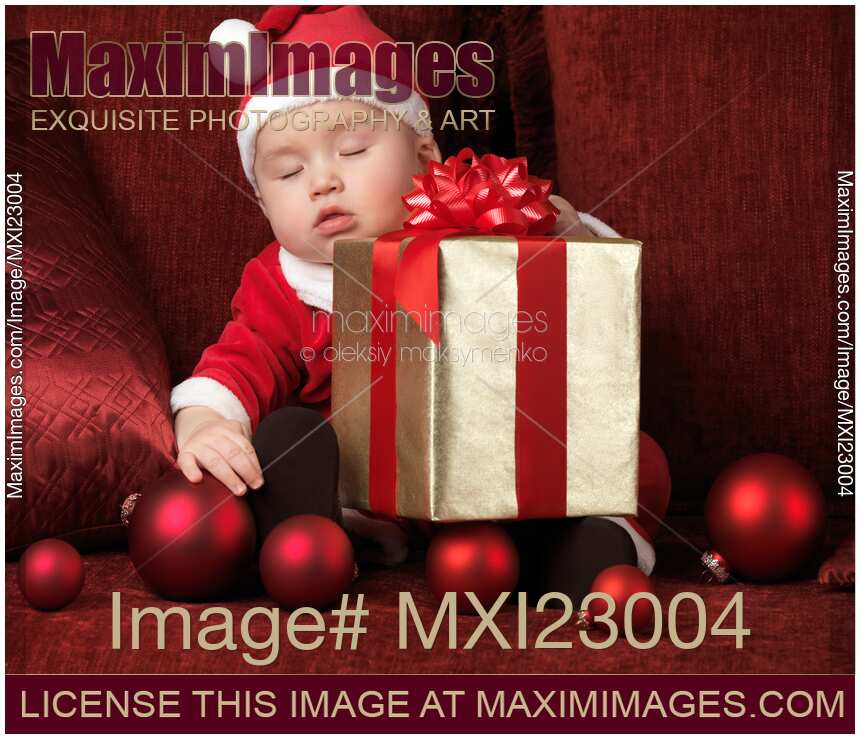 Baby Boy in Santas Costume Sleeping with a Present