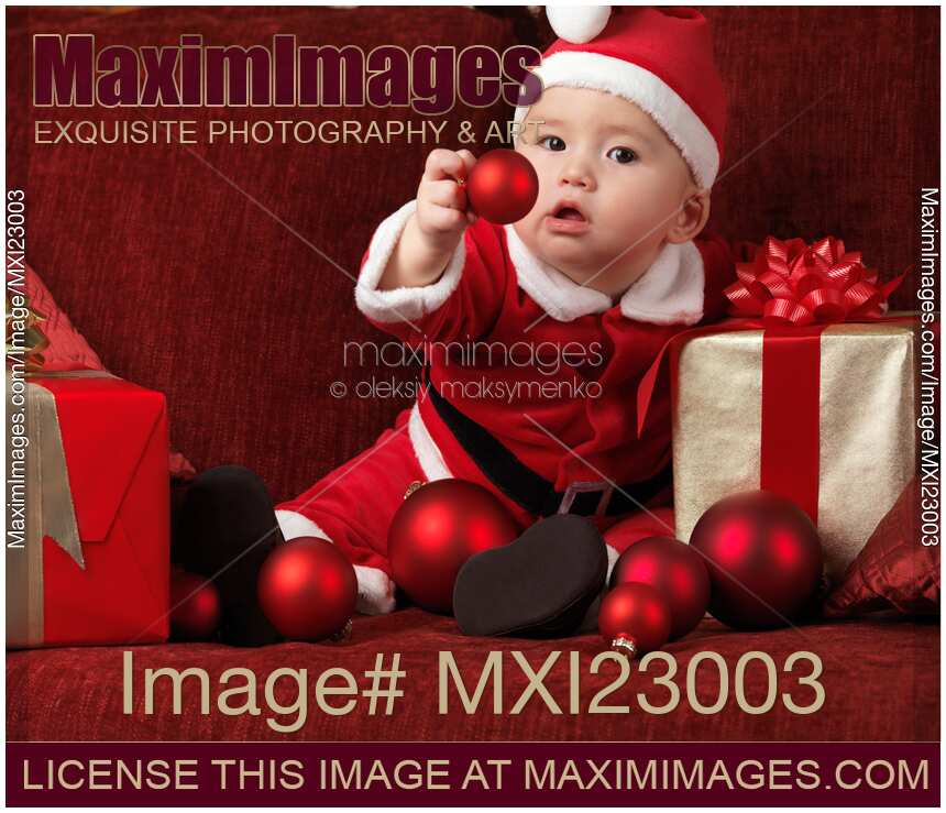 Baby Boy in Santas Costume with Christmas Baubles