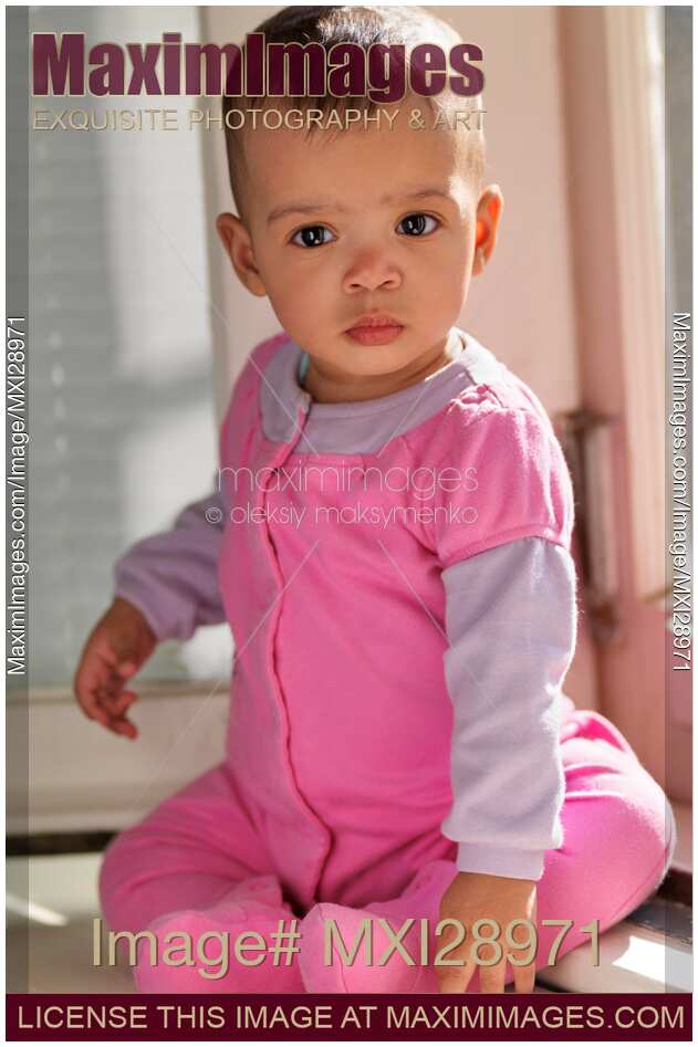 Baby Girl Sitting on a Window Sill