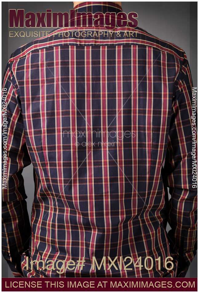 Back of a man wearing dark red tartan shirt