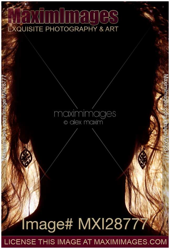 Backlit woman face dark silhouette