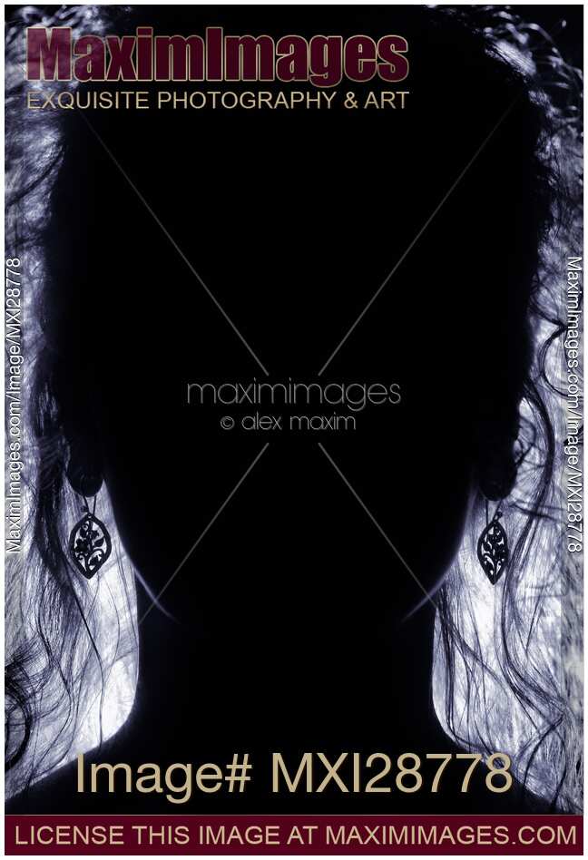 Backlit woman face with long hair dark silhouette
