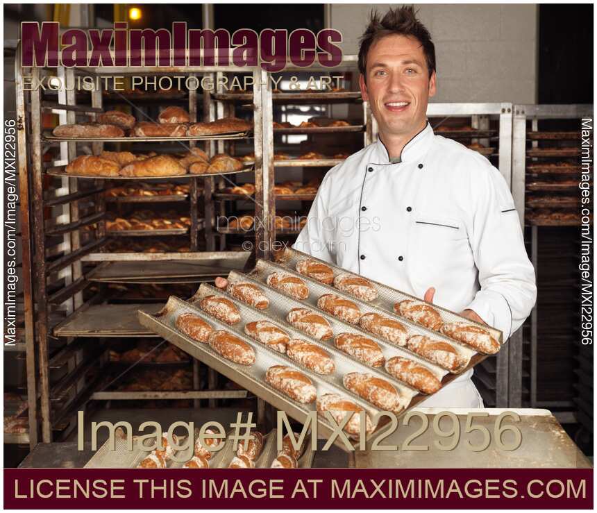 Baker with Freshly Baked Breads on a Tray