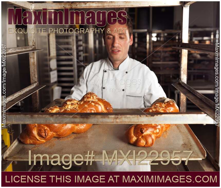Baker with Freshly Baked Breads on a Tray