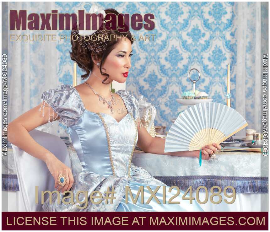 Beautiful asian woman sitting with a fan