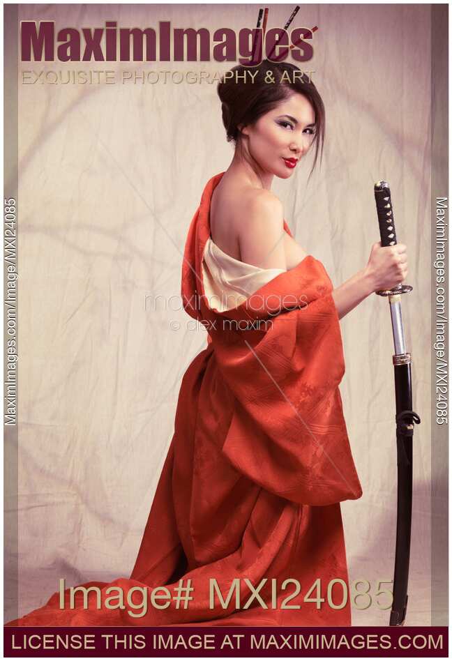 Beautiful asian woman unsheathing a sword