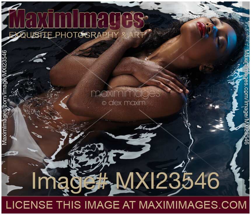 Beautiful black african-american woman lying in water half-naked Sensual portrait
