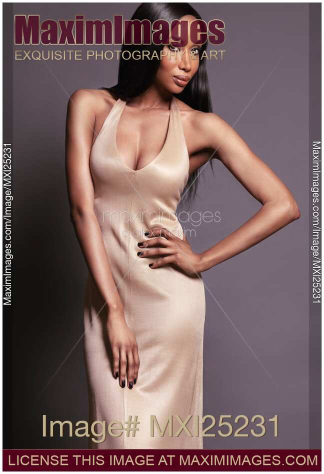 Beautiful black woman wearing long gold dress