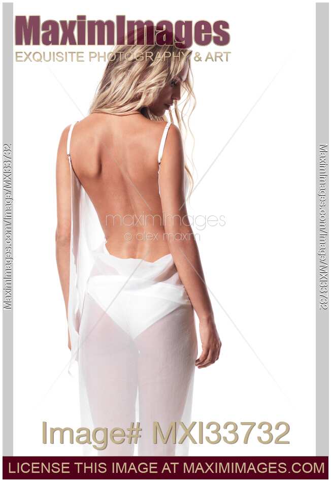 Beautiful blond young woman wearing white beachwear beach cover dress with open back