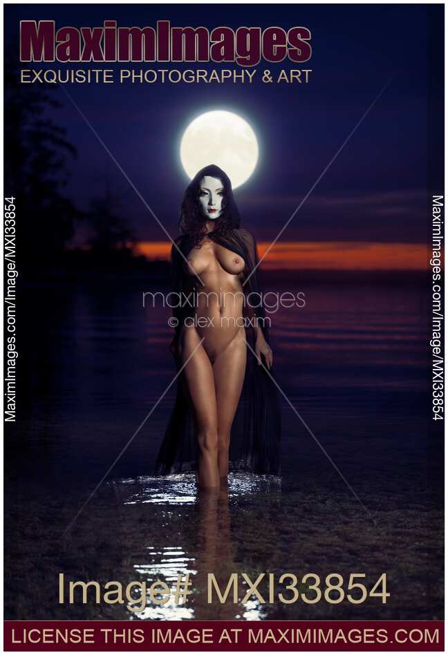 Beautiful mysterious woman in white face mask with sensual nude body walking out of the water like a goddess in full moon. Moon Goddess.