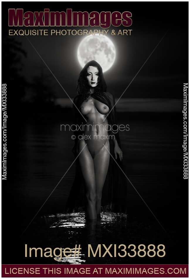 Beautiful mysterious woman in white face mask with sensual nude body walking out of the water like a goddess in full moon. Black and white
