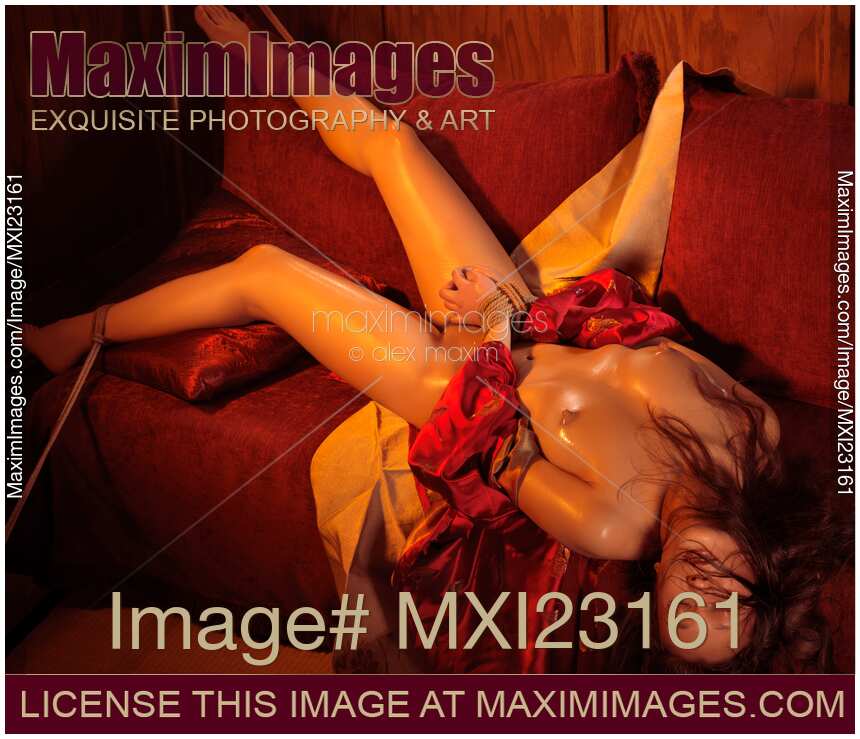 Beautiful naked asian woman lying in sensual pose tied up with rope bondage Shibari