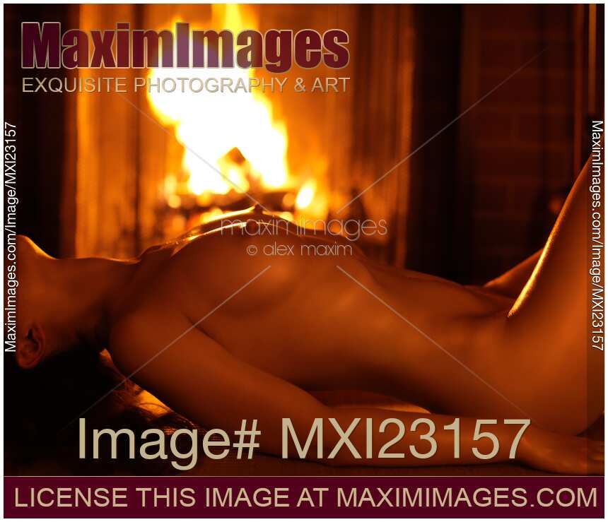 Beautiful Naked Woman at a Fireplace