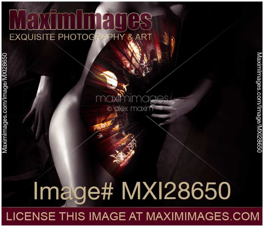 Beautiful naked woman body covered with oriental red fan Artistic nude Zen