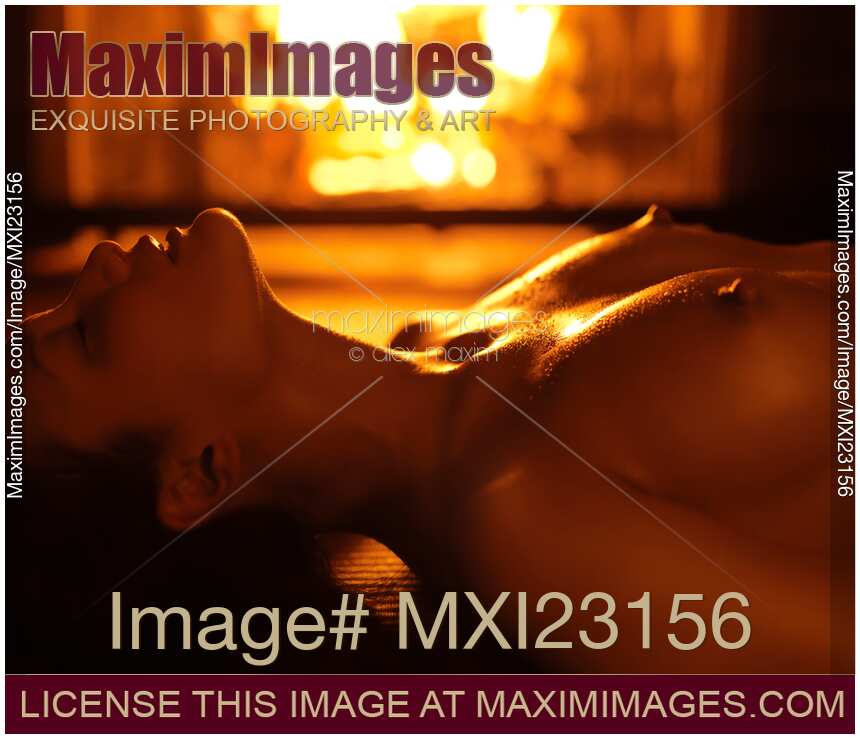 Beautiful Naked Woman in Front of a Fireplace