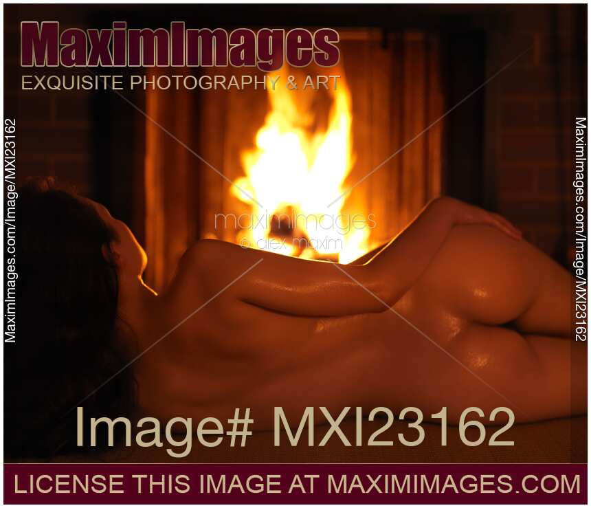 Beautiful Naked Woman in Front of a Fireplace