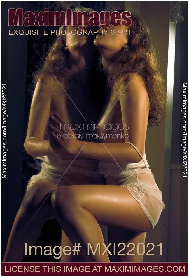 Beautiful Naked Woman Leaning Against a Mirror